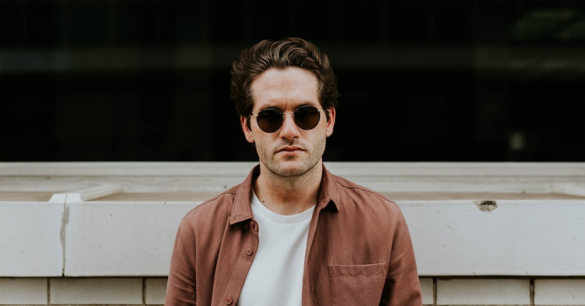 Man showcasing top short curly hairstyle for a trendy look.