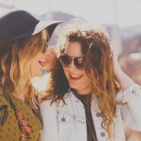 Friends embracing with joyful expressions, symbolizing cherished friendship. Friends embracing with joyful expressions, symbolizing cherished friendship.