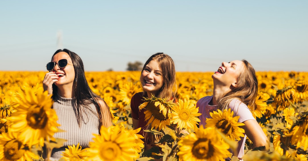 Friends hugging, celebrating with inspirational anniversary quotes.
