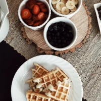 Couple enjoys cozy anniversary breakfast with heart-shaped pancakes. Couple enjoys cozy anniversary breakfast with heart-shaped pancakes.