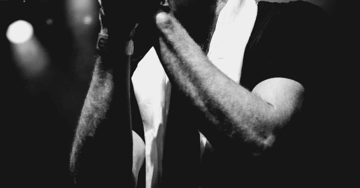 Anniversary song lyrics backdrop with hearts and romantic vibe.