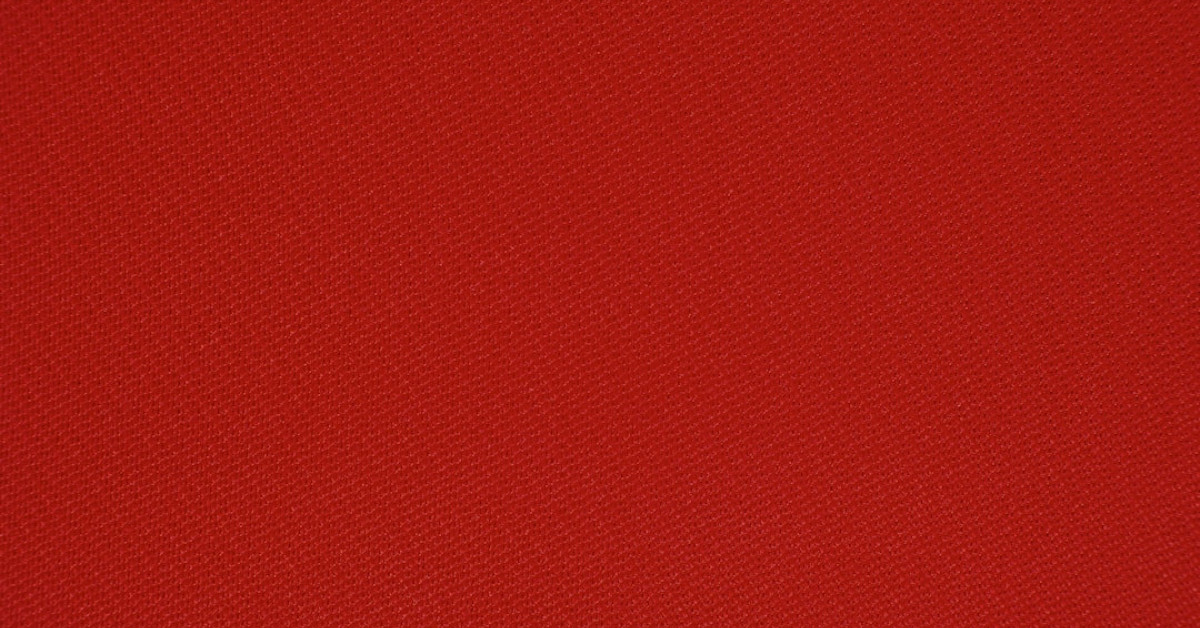 Stylish red hiking boots on rugged trail.