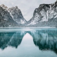 Mountain bikers cresting hill against a scenic backdrop Mountain bikers cresting hill against a scenic backdrop