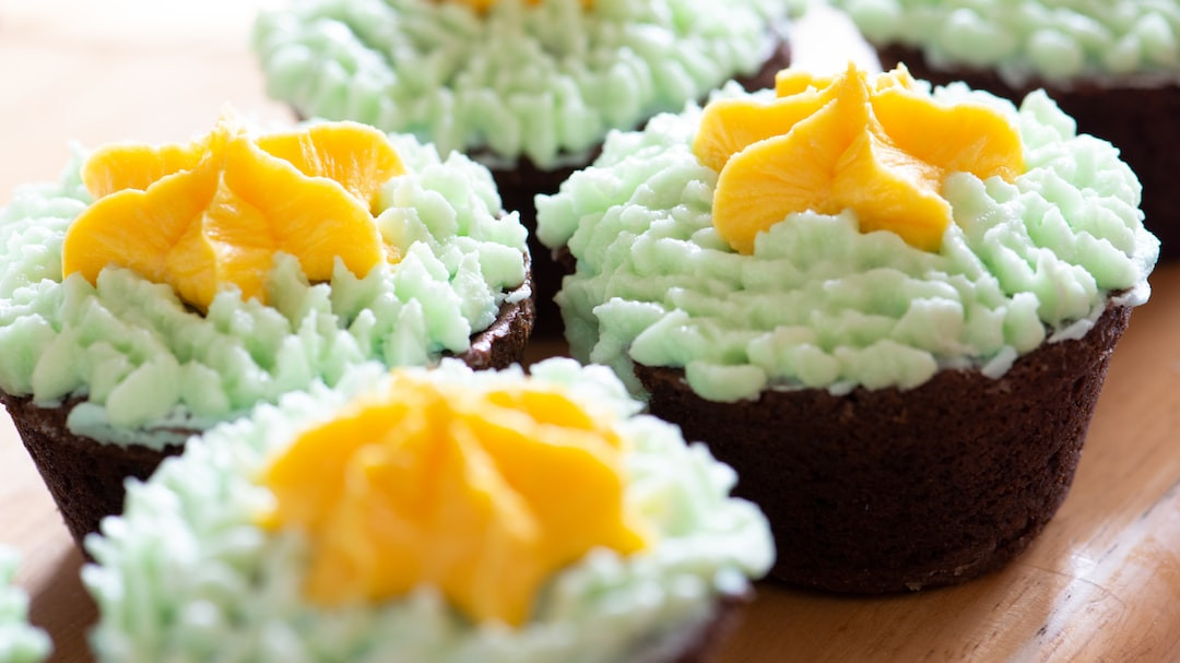 Green tea cupcakes with frosting on a white plate.