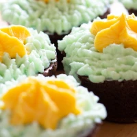 Green tea cupcakes with frosting on a white plate. Green tea cupcakes with frosting on a white plate.