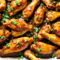 Honey lemon pepper wings on plate with garnish Honey lemon pepper wings on plate with garnish