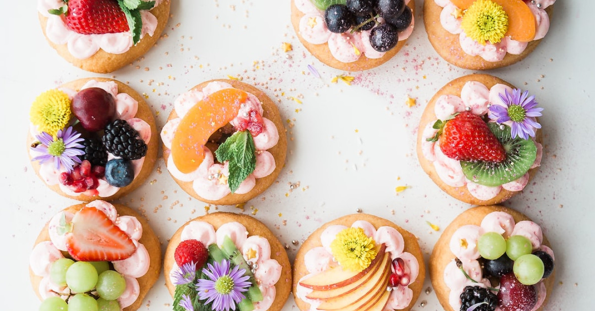 Chef presenting dish with 'Ultimate Lectern' recipe book nearby.