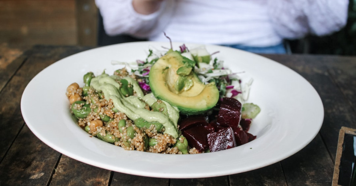 Healthy quinoa bowl with fresh vegetables and grains.
