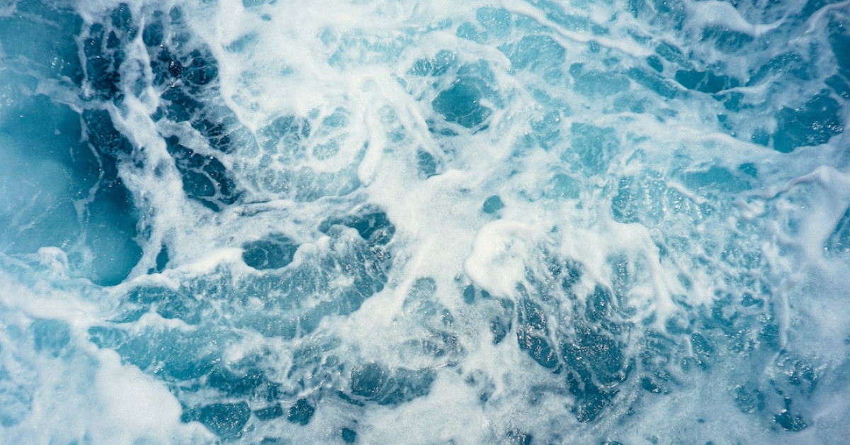 Freediver descending into deep ocean abyss