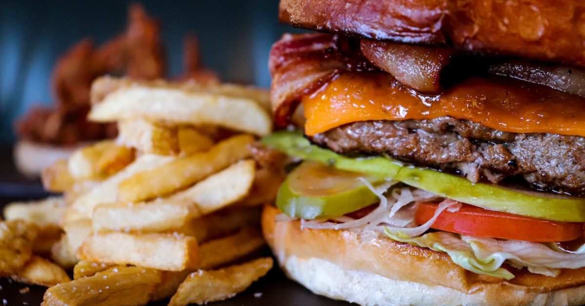 Bacon press in action flattening bacon for perfect crispiness.