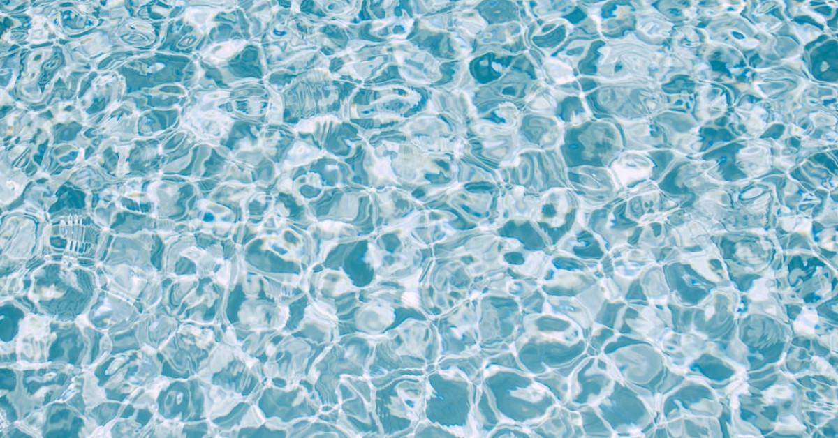 Fiji water bottle enhances coffee experience at breakfast table.