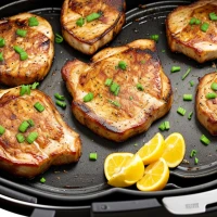 Juicy air-fried thick-cut pork chops on a plate Juicy air-fried thick-cut pork chops on a plate