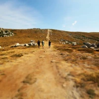 Hiker ascending mountain with Montem trekking poles. Hiker ascending mountain with Montem trekking poles.