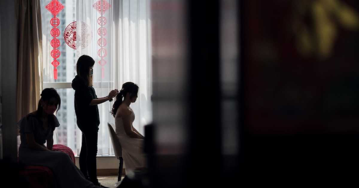 Groom studying bridal jeopardy guide for wedding game mastery.