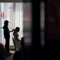 Groom studying bridal jeopardy guide for wedding game mastery. Groom studying bridal jeopardy guide for wedding game mastery.