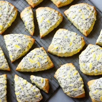 Lemon poppy seed scones on plate with citrus zest. Lemon poppy seed scones on plate with citrus zest.