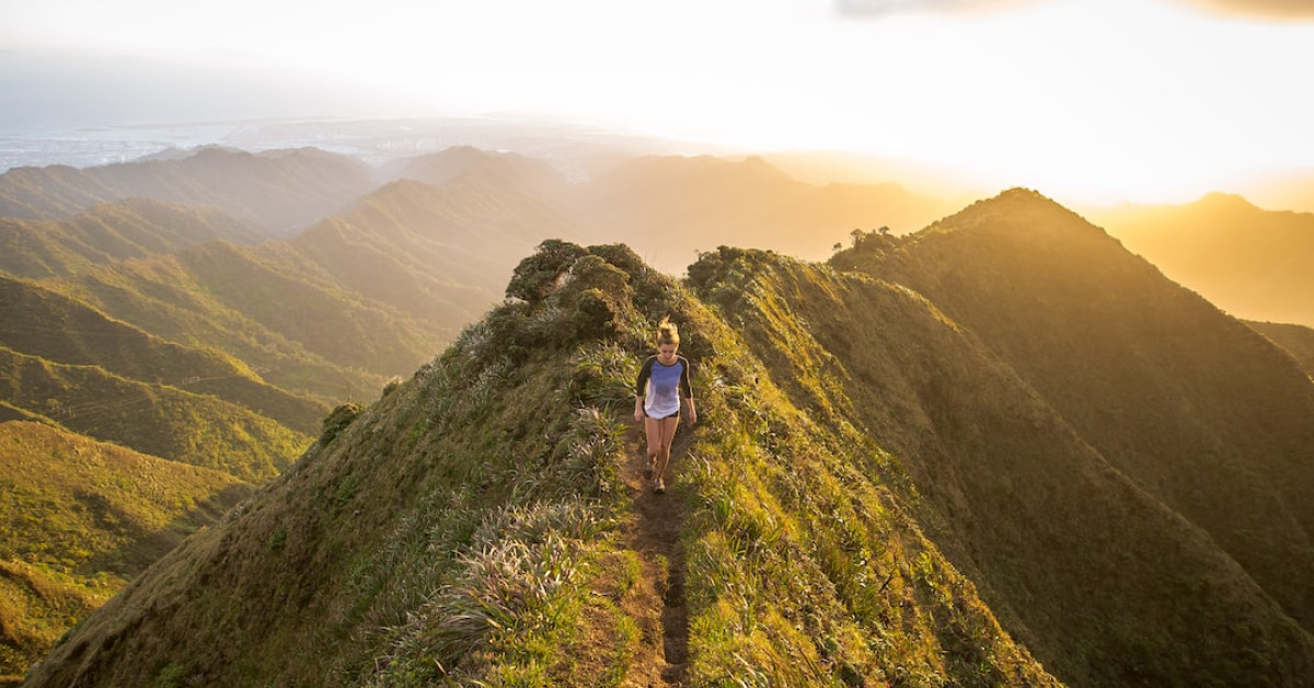 Redwing hiking boots on rocky trail outdoors.