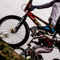 Pro cyclist mastering hill climb during intense training session. Pro cyclist mastering hill climb during intense training session.