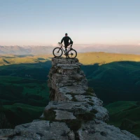 Cyclist pushing hard during intense outdoor leg workout session. Cyclist pushing hard during intense outdoor leg workout session.
