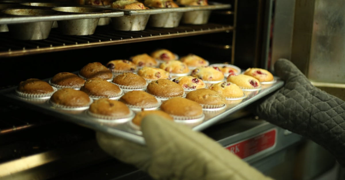Breaded baked cod with lemon garnish on dinner plate.
