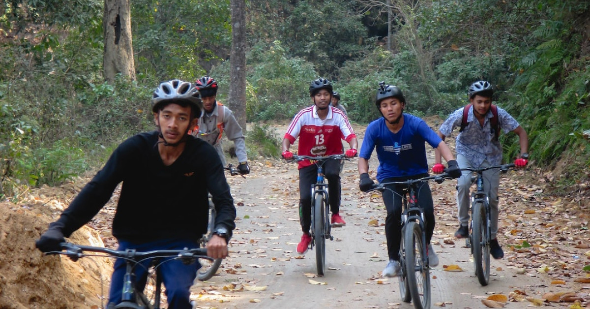 Person cycling outdoors, enjoying health benefits of road biking.
