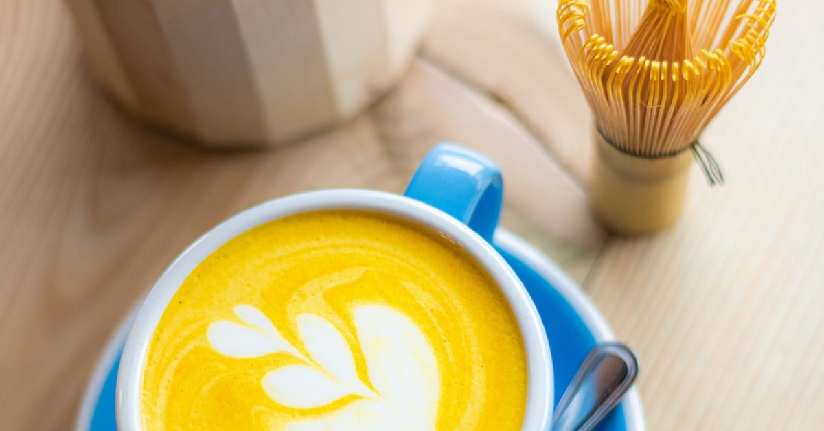 Pumpkin chai latte on table with autumn decoration