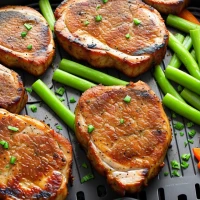 Air-fried thick pork chops with colorful side vegetables. Air-fried thick pork chops with colorful side vegetables.