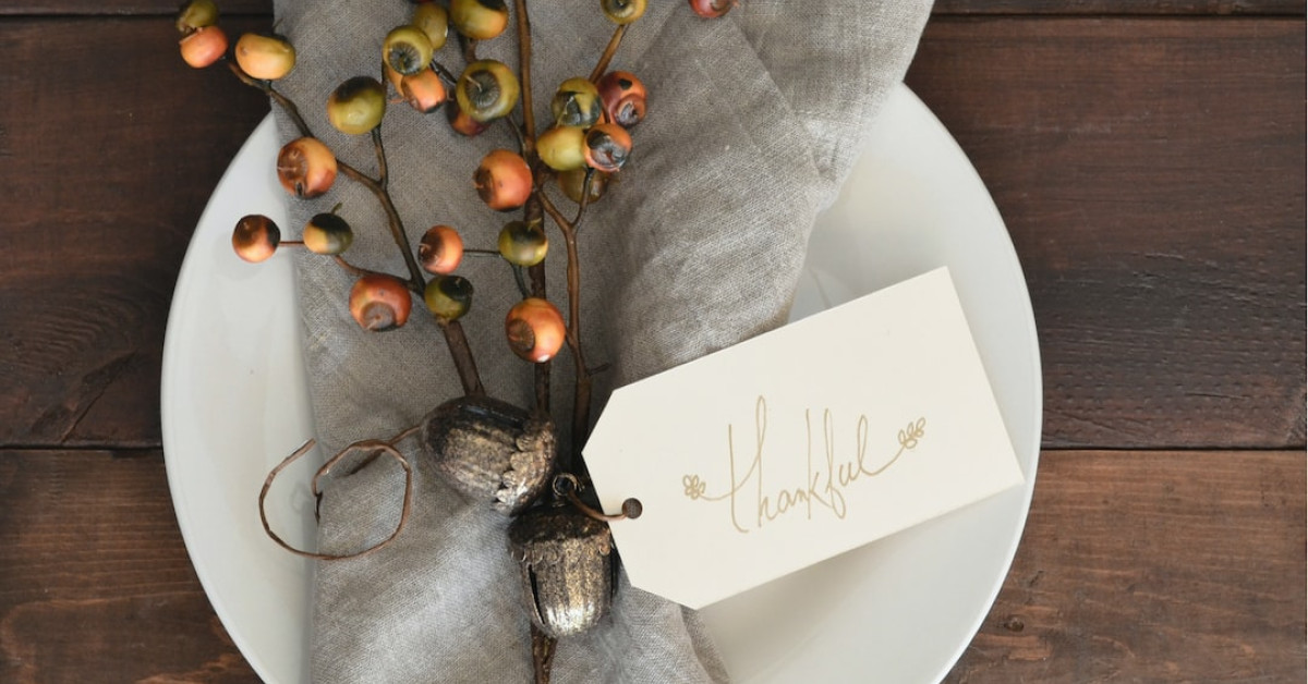 Starbucks holiday-themed cup amidst Thanksgiving festive decorations.
