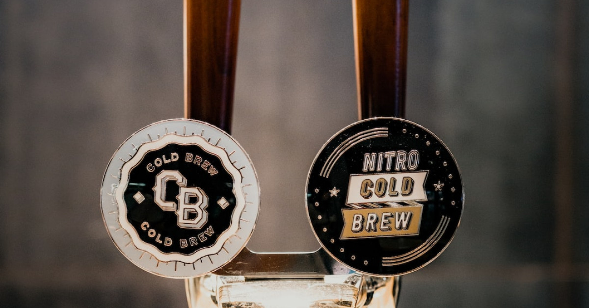 Hand holding Venti Starbucks coffee cup for delightful taste.