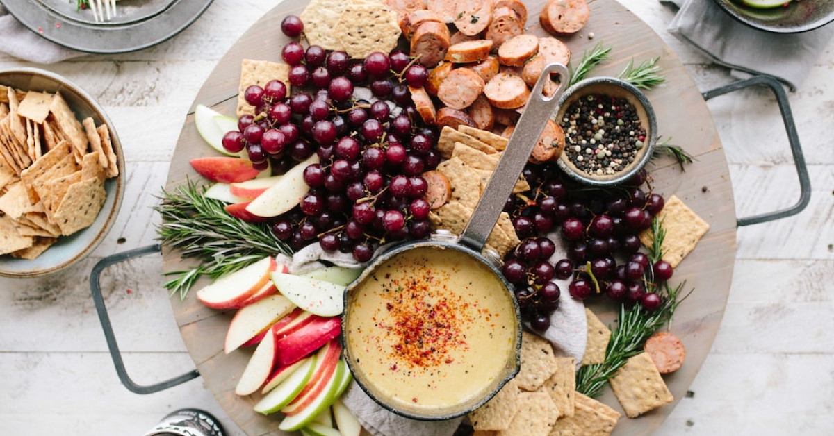 Apple sausage dish presentation on a wooden board.