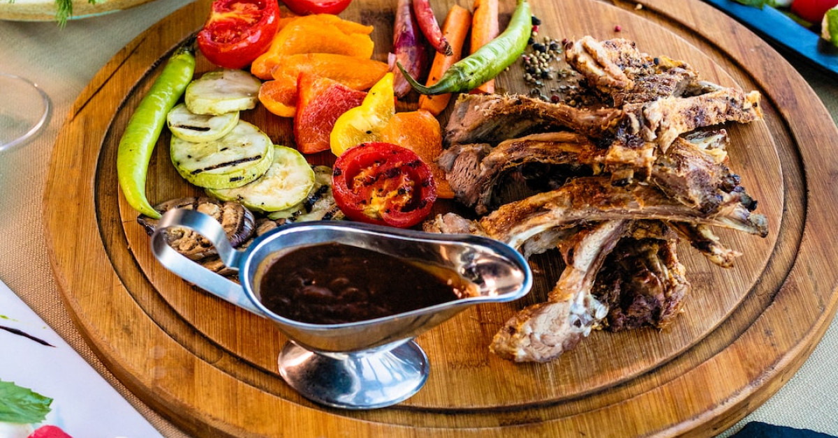 Veal tonnato dish garnished with capers and lemon slice.