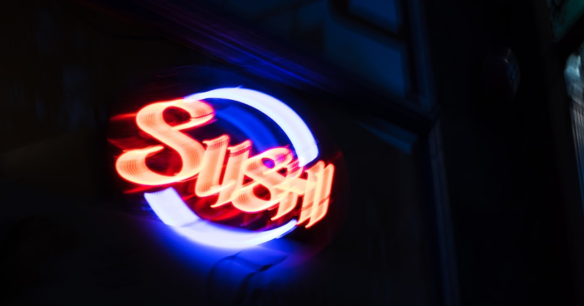 Shrimp sushi bake with colorful veggies on a white plate.