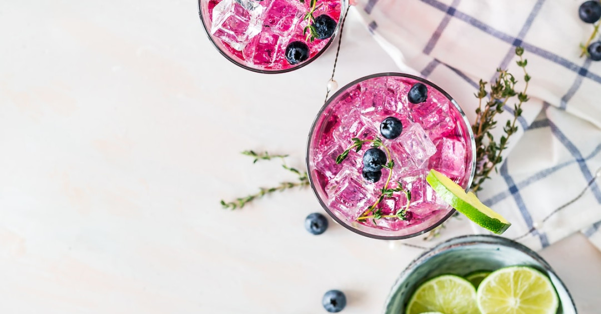 Coffee cup surrounded by tropical fruits with a smoothie guide.