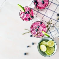 Coffee cup surrounded by tropical fruits with a smoothie guide. Coffee cup surrounded by tropical fruits with a smoothie guide.
