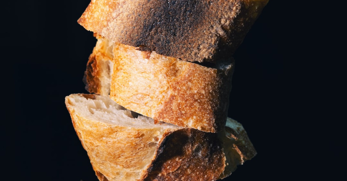 Spinach dip in bread bowl with fresh veggies.