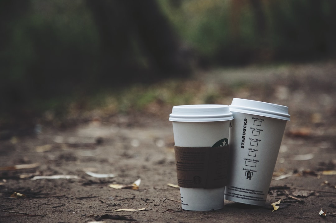 Starbucks autumn-themed cups on wooden table.