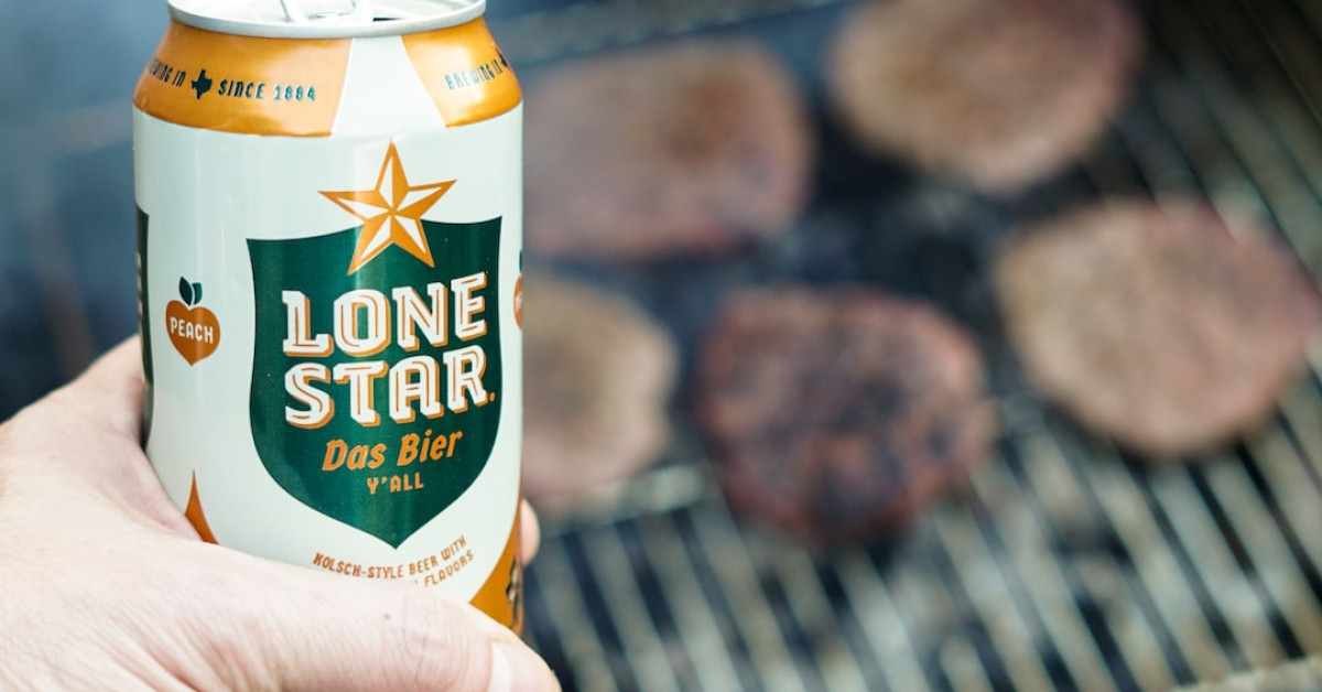 Spicy Texas chili bowl with toppings on wooden table.
