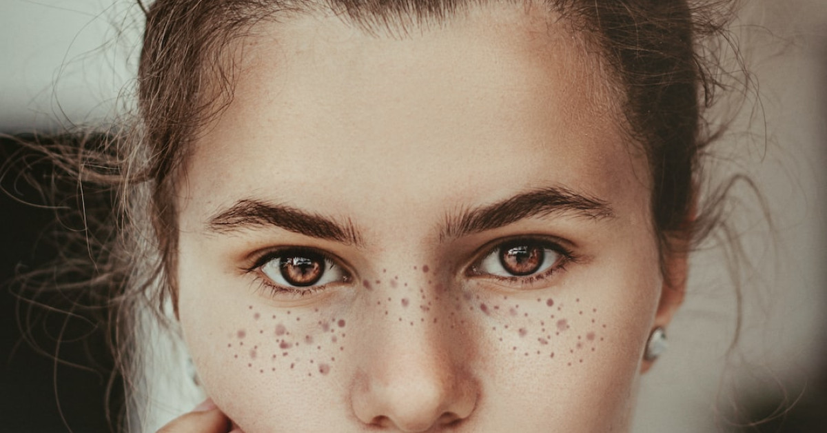 Diver mid-air during split-face cliff diving; caution advised.