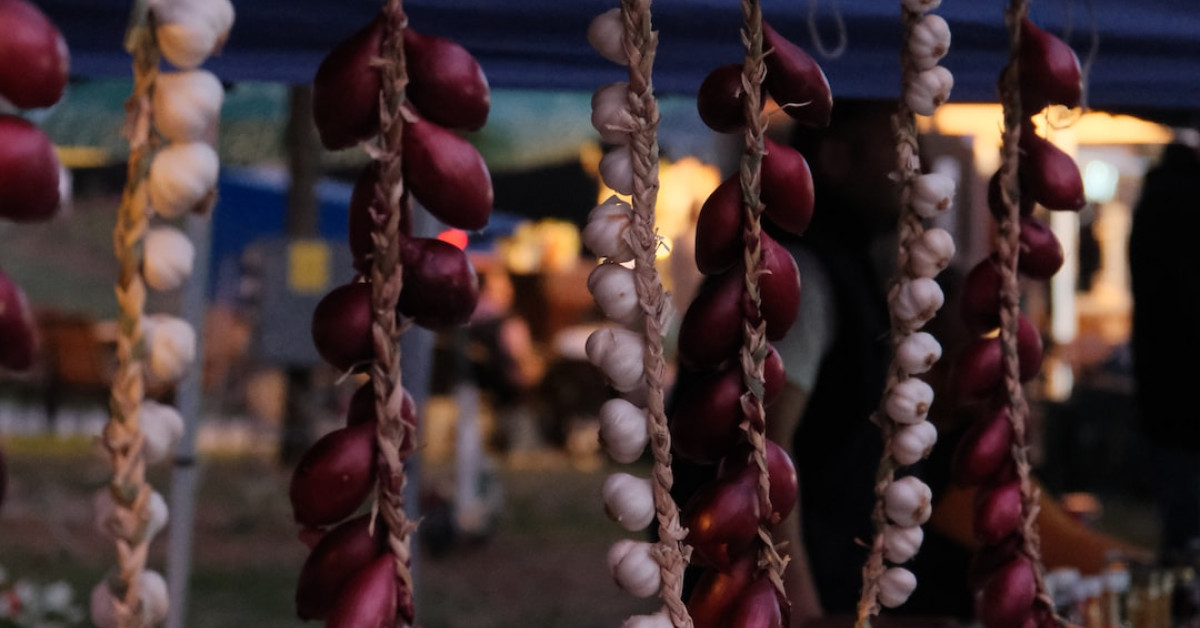 Crispy fried onion strings appetizer on white plate.