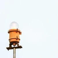 Person trekking with adjustable walking pole on mountain trail. Person trekking with adjustable walking pole on mountain trail.