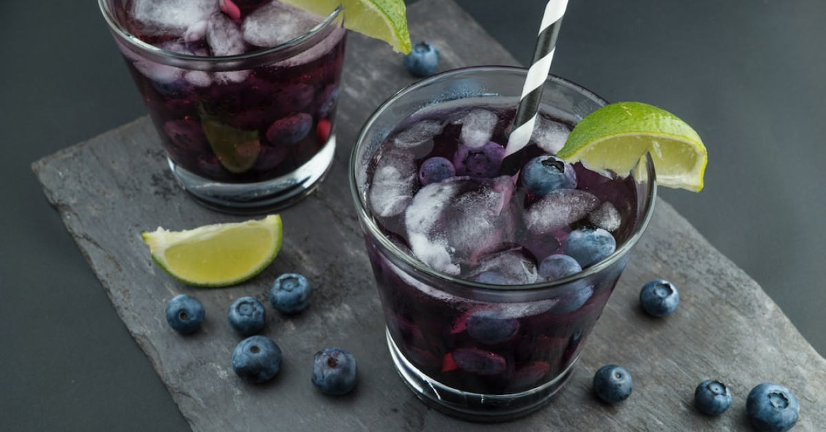 Starbucks high-caffeine drink in a takeaway cup on table.