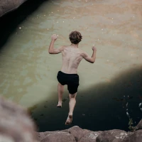 Deep-sea diver examining mysterious Paria wreckage underwater. Deep-sea diver examining mysterious Paria wreckage underwater.