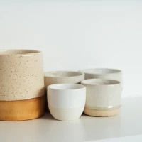 Rustic barrel bowls display culinary elegance on wooden table. Rustic barrel bowls display culinary elegance on wooden table.