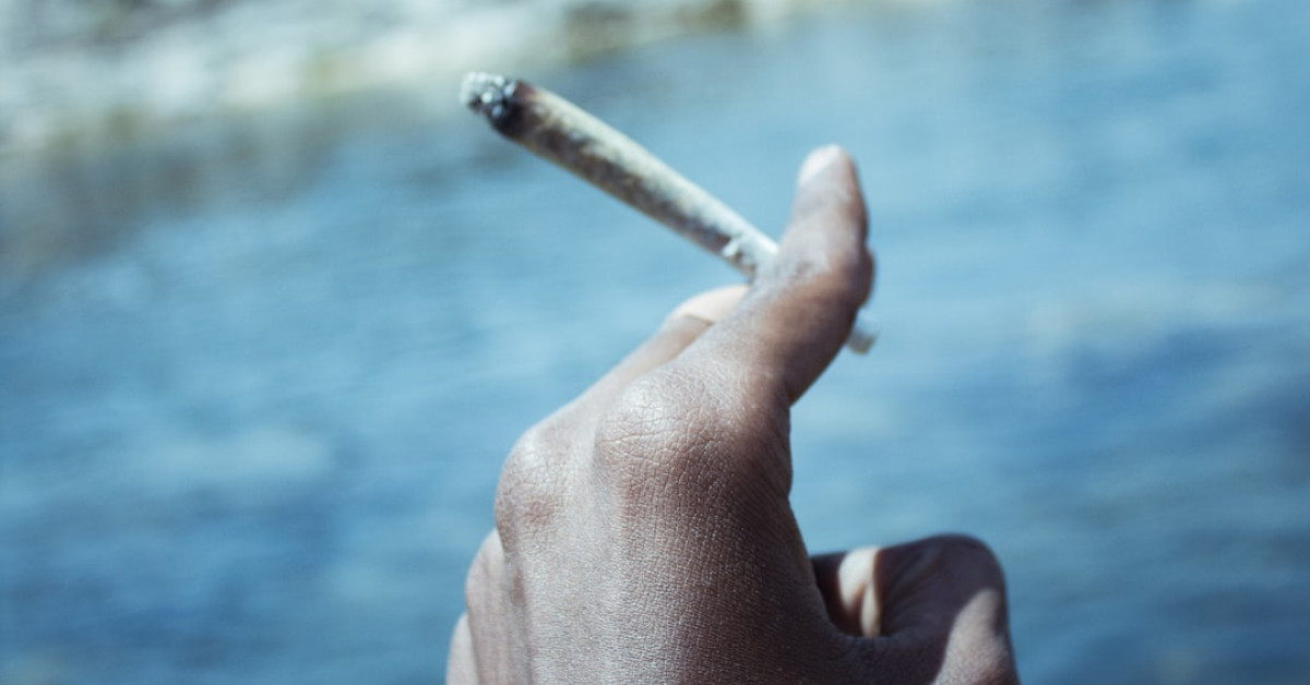 Smoked brisket on grill with temperature guide.