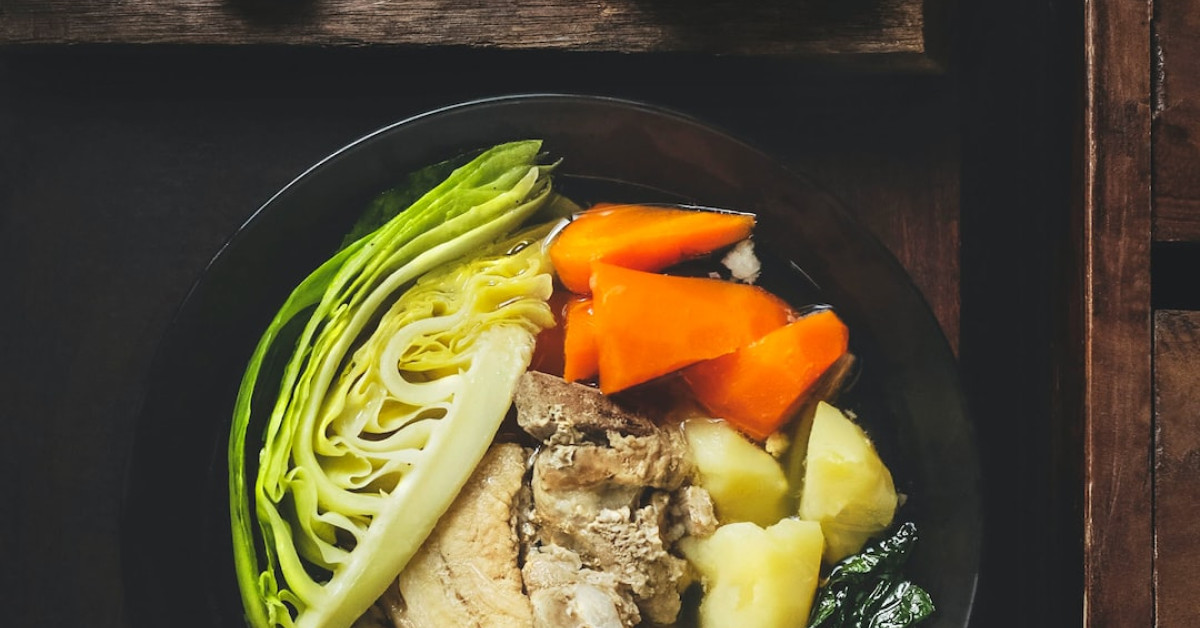 Delicious chicken rice bowl topped with fresh herbs and vegetables.