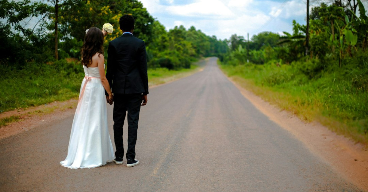 Modern groom in black and green wedding suit