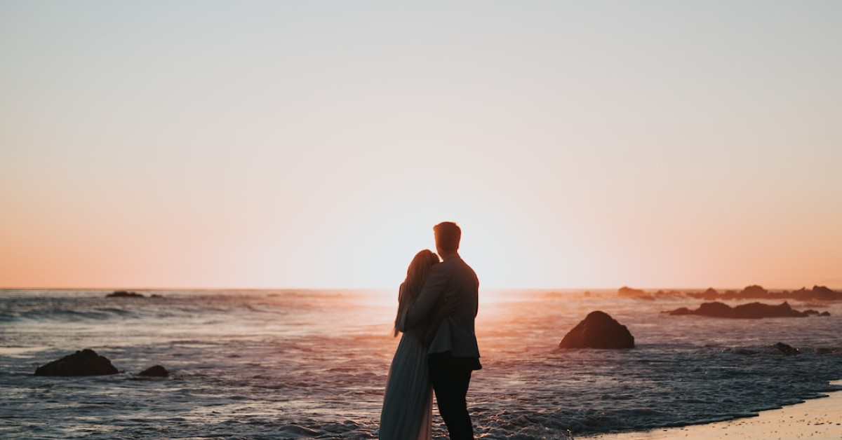 Couple celebrating with wedding anniversary quotes backdrop.